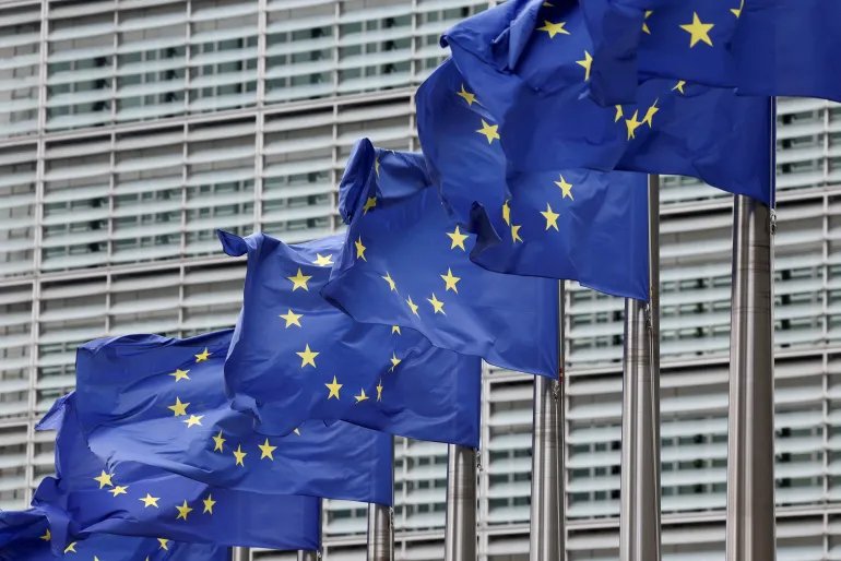 FILE PHOTO: European Union flags flutter outside the EU Commission headquarters, on the day farmers protest against proposed cuts to Common Agricultural Policy (CAP) funding and the European Commission's plan to merge agricultural and cohesion policies, in Brussels, Belgium July 16, 2025. REUTERS/Yves Herman/File Photo