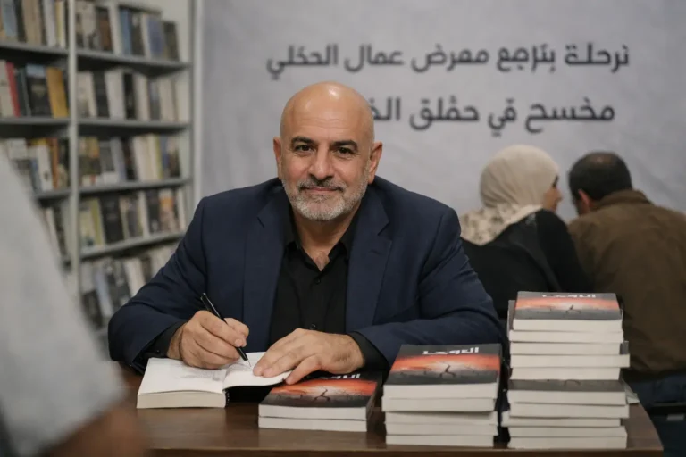 Author signs books at Arabic-language book event