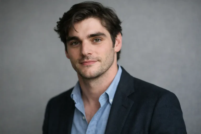 Professional headshot of a man in a navy blazer